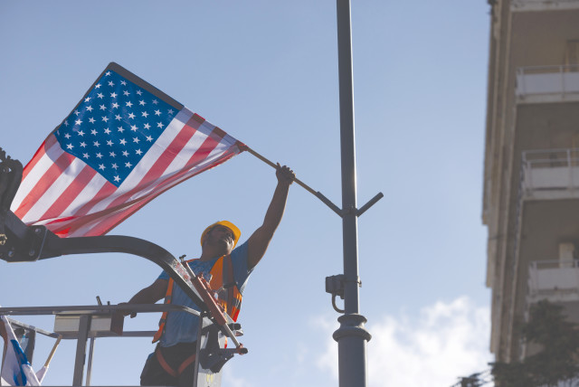  A JERUSALEM MUNICIPALITY worker hangs an American flag in Jerusalem, on Sunday in preparation for the upcoming visit of President Joe Biden. Let’s see America forever stand by allies like Israel, says the writer.  (credit: YONATAN SINDEL/FLASH90)
