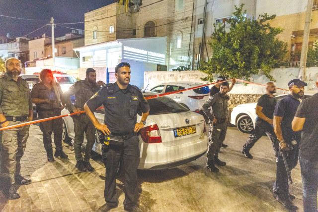  POLICE AND MEDICAL personnel at the scene of the murder of a woman in Lod. (credit: YOSSI ALONI/FLASH90)