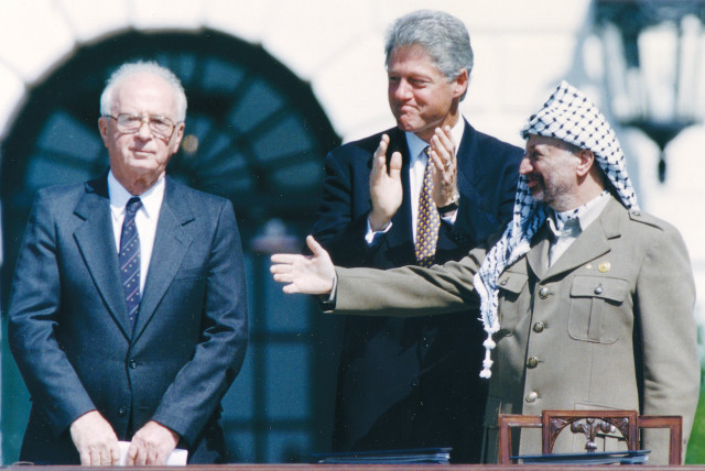  THE 1993 OSLO Accords between Israel and the PLO were signed in Washington, with a beaming president Bill Clinton presiding over the White House ceremony (credit: GARY HERSHORN/REUTERS)