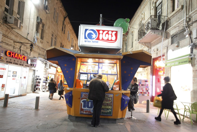  An Israeli man plays the lottery at a lotto booth in the center of Jerusalem (credit: MIRIAM ALSTER/FLASH90)