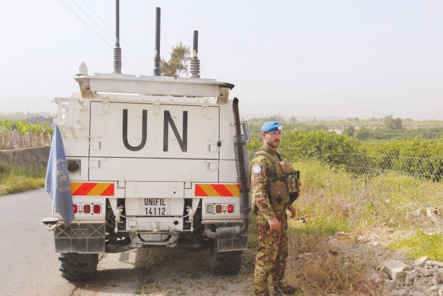  A UNIFIL peacekeeper stands next to a UN vehicle in southern Lebanon, in April (credit: AZIZ TAHER/REUTERS)
