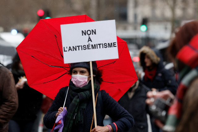  A demonstrator holds a sign that reads 'no to antisemitism', during a protest against antisemitism and to commemorate the 2012 Toulouse attack against a Jewish school that left three children and an adult dead, at the Place de la Republique square in Paris, France, March 13, 2022.  (credit: REUTERS/BENOIT TESSIER)