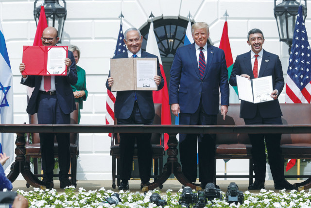  AFTER SIGNING the Abraham Accords, then-prime minister Benjamin Netanyahu and the foreign ministers of Bahrain (left) and UAE display their copies as then-US president Donald Trump looks on, at the White House, September 15, 2020. (photo credit: TOM BRENNER/REUTERS)