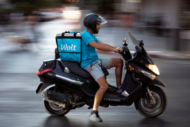  A courier working with Wolt, a meal delivery app service, rides a scooter as he delivers an order from a restaurant, amid the coronavirus disease (COVID-19) crisis, in Tel Aviv, Israel July 9, 2020. (credit: REUTERS/AMIR COHEN)