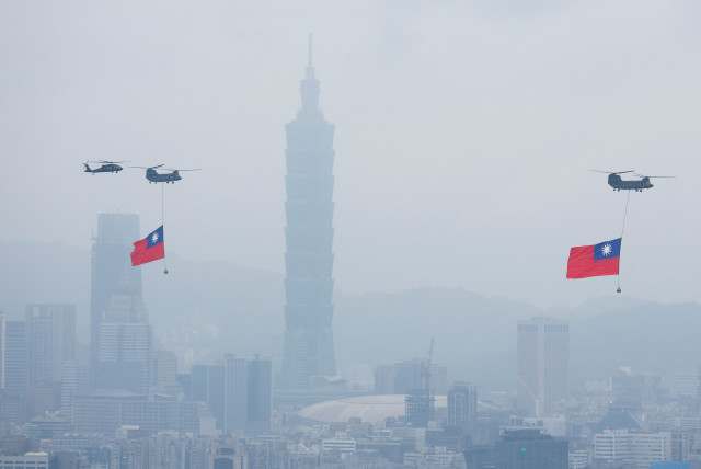  Chinook helicopters carrying Taiwan flags fly near the Taipei 101 skyscraper during the country's National Day celebration in Taipei, Taiwan (credit: REUTERS)
