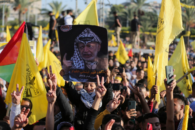  Palestinians take part in a Fatah rally marking the 18th anniversary of the death of late Palestinian leader Yasser Arafat, in Gaza City November 10, 2022. (credit: REUTERS/ IBRAHEEM ABU MUSTAFA)