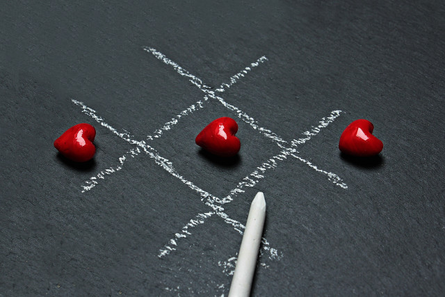  Illustration of tic-tac-toe board with love hearts. (credit: PEXELS)