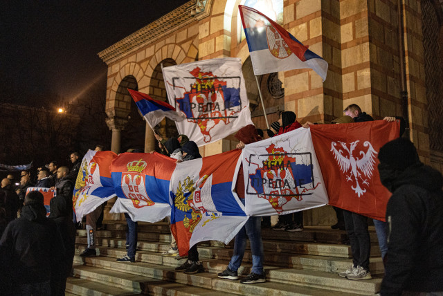  Demonstrators hold flags during a rally in support of ethnic Serbs who are protesting against Pristina government actions in northern Kosovo, in Belgrade, Serbia, December 12, 2022.  (photo credit: MARKO DJURICA/REUTERS)