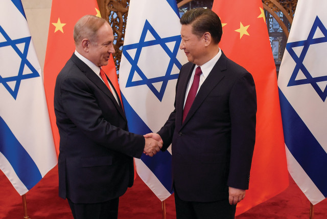  PRIME MINISTER Benjamin Netanyahu shakes hands with Chinese President Xi Jinping ahead of talks in Beijing, in 2017.  (credit: Etienne Oliveau/Reuters)