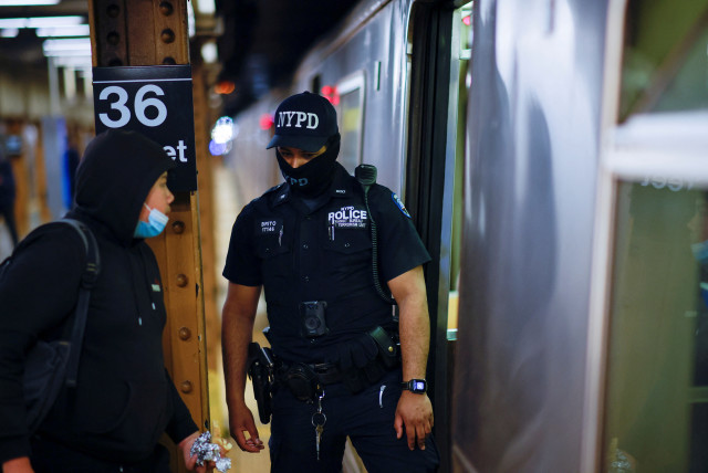  A New York police officer of the anti-terrorism unit patrols the 36th St. subway station, a day after a shooting incident took place in the Brooklyn borough of New York City, US, April 13, 2022 (photo credit: REUTERS/EDUARDO MUNOZ)