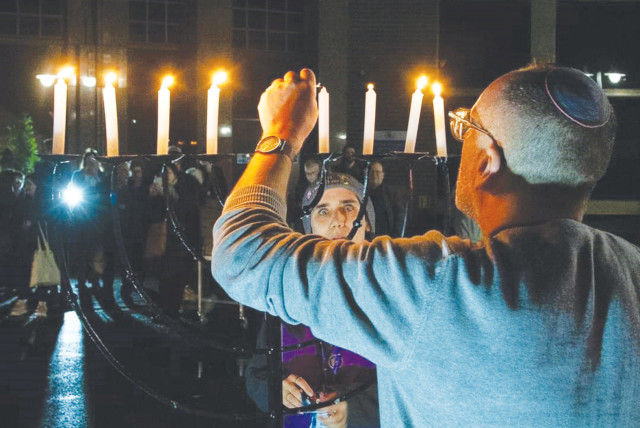  LIGHTING THE Hanukkah candles at a Limmud conference last month. (credit: LIMMUD)