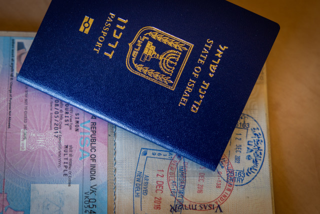 An illustration picture shows a new Israeli passport and an Old Israeli passport with American Visa in Jerusalem, on January 18, 2023. (credit: NATI SHOHAT/FLASH90)