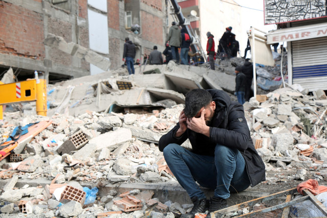  A man reacts at the site of a collapsed building in the aftermath of a deadly earthquake in Diyarbakir, Turkey February 8, 2023. (credit: REUTERS/SERTAC KAYAR)