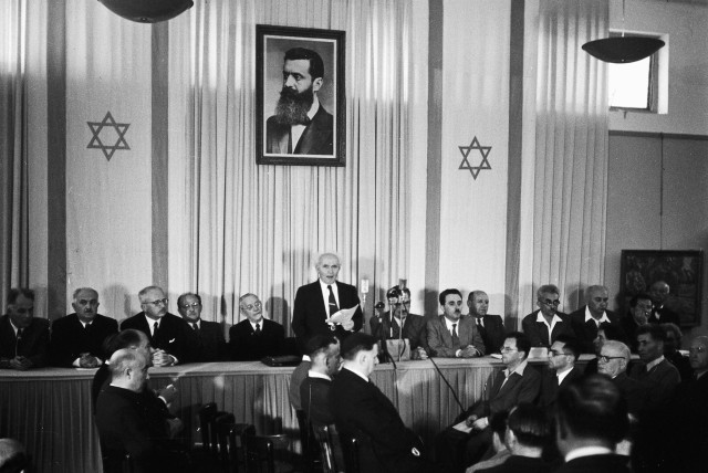  David Ben-Gurion declares Israel’s independence in Tel Aviv on May 14, 1948, underneath a portrait of Zionist visionary Theodor Herzl. (photo credit: RUDI WEISSENSTEIN)