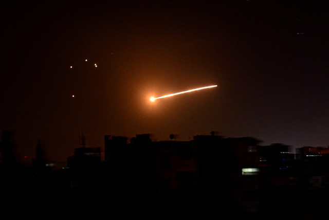 A streak of light is seen in the night sky in the vicinity of the Syrian capital Damascus during what Syrian authorities said was an Israeli air strike, in this handout released by state news agency SANA on February 24, 2020. (photo credit: SANA/HANDOUT VIA REUTERS)