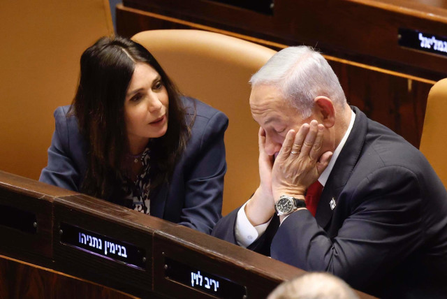  Israeli Prime Minister Benjamin Netanyahu is seen sitting with his face in his hands next to Transportation Minister Miri Regev in the Knesset plenum in Jerusalem, on February 20, 2023. (credit: MARC ISRAEL SELLEM/THE JERUSALEM POST)