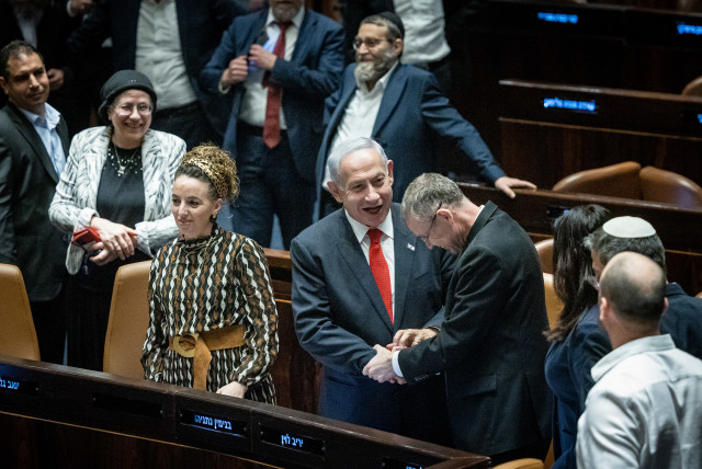  Israeli Prime Minister Benjamin Netanyahu, Justice Minister Yariv Levin and coalition members celebrate after a vote on the government's judicial overhaul plans in the assembly hall of the Knesset, the Israeli parliament in Jerusalem, on February 21, 2023. (credit: YONATAN SINDEL/FLASH90)