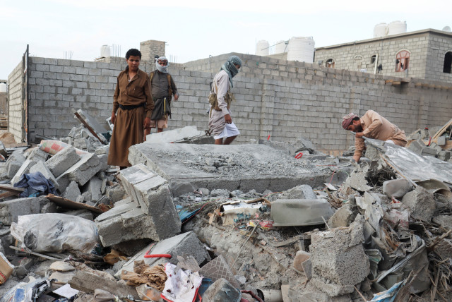  People browse through the rubble of a house destroyed by Houthi missile attack in Marib, Yemen, October 3, 2021 (credit: REUTERS/ALI OWIDHA)