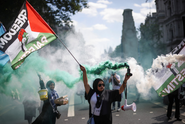  A protester carries a smoke flare during a pro-Palestine demonstration outside Downing Street in London, Britain, June 12, 2021. (credit: REUTERS/HENRY NICHOLLS)