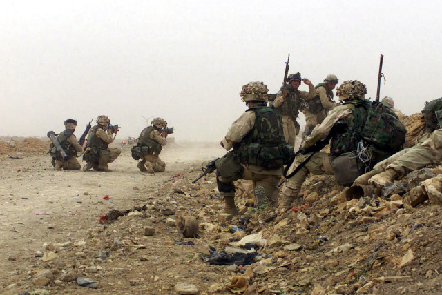 US Marine Corps (USMC) Marines assigned to C/Company, 1ST Battalion, 5th Marines, 1ST Marine Division engage the enemy during a firefight with Iraqi Forces near Baghdad, Iraq, during Operation IRAQI FREEDOM (credit: NARA)