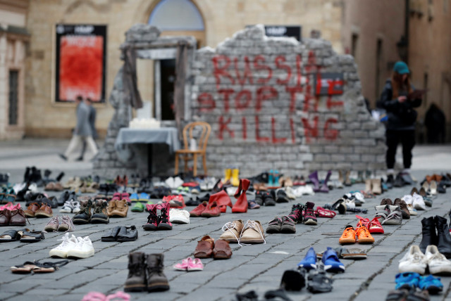 Shoes symbolizing war crimes committed against Ukrainian civilians are placed at the Old Town Square to mark the one-year anniversary of the Russian invasion of Ukraine, in Prague, Czech Republic February 15, 2023 (credit: REUTERS/DAVID W CERNY)