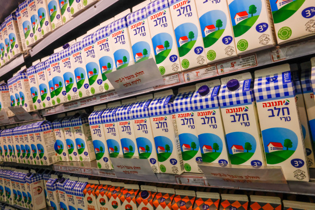 Milk, with a sign reading 'the milk is limited to 2 cartons per customer,' is seen in a Jerusalem supermarket on March 22, 2023  (credit: MARC ISRAEL SELLEM/THE JERUSALEM POST)