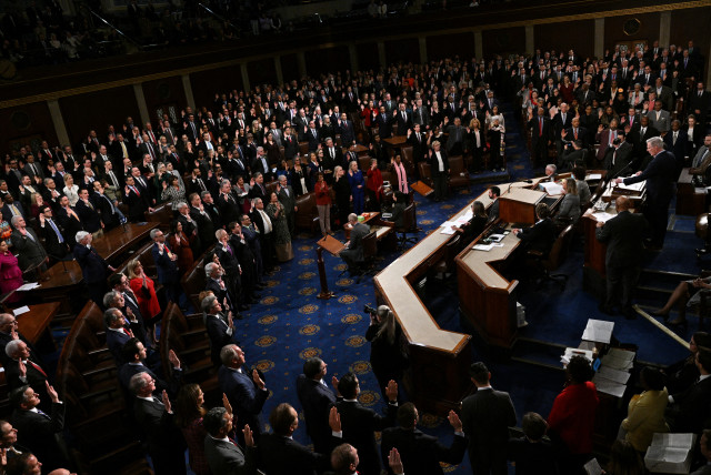 Members of the 118th Congress raise their right hands as they are sworn into office to serve in the US House of Representatives on the fourth day of Congress at the US Capitol in Washington, US, January 7, 2023. (credit: REUTERS/JON CHERRY)
