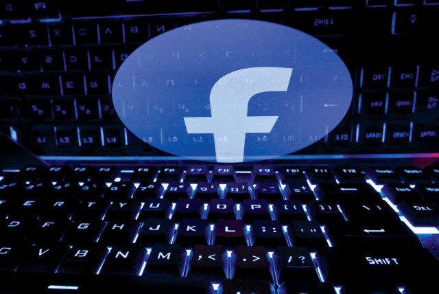  A keyboard is placed in front of a displayed Facebook logo in this picture illustration. (credit: DADO RUVIC/REUTERS)