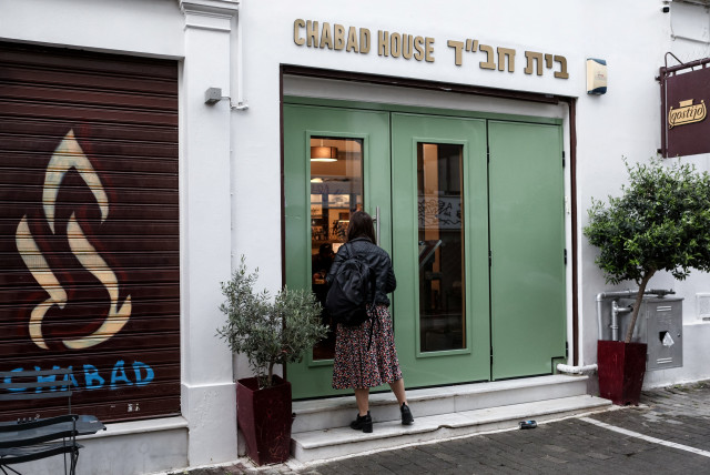  A woman looks through the entrance of an Israeli restaurant, following the arrest by Greek police of two suspected members of a group that was planning an attack against the restaurant, in Athens, Greece, March 28, 2023. (photo credit: Vassilis Rebapis/Eurokinissi via REUTERS)