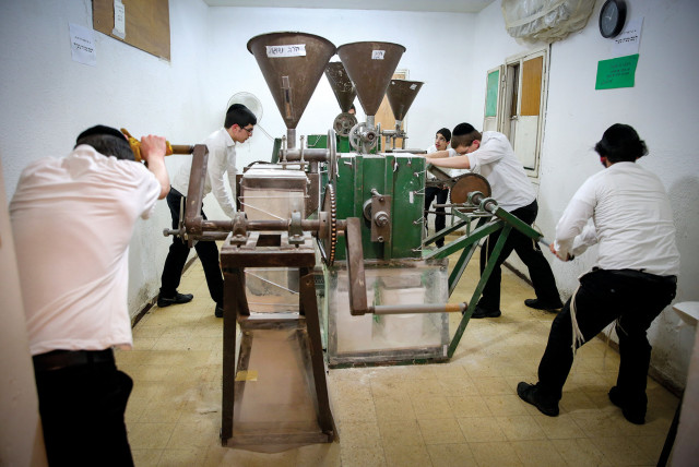  GRINDING FLOUR for making matzot in Bnei Brak.  (photo credit: Yaacov Cohen/Flash90)
