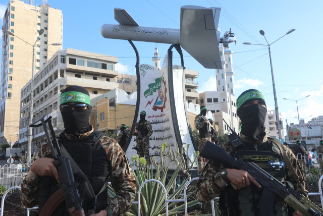 Palestinian members of Izz ad-Din al-Qassam Brigades, the armed wing of the Hamas movement seen next to a memorial named “Shehab Field,” a drone made by al-Qassam, in Gaza City, September 21, 2022. (credit: ATTIA MUHAMMED/FLASH90)