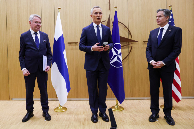  NATO Secretary-General Jens Stoltenberg speaks as Finnish Foreign Minister Pekka Haavisto hands his nation's accession document to US Secretary of State Antony Blinken during a joining ceremony at the NATO foreign ministers' meeting at the Alliance's headquarters in Brussels, Belgium April 4, 2023. (credit: Johanna Geron/Pool/Reuters)