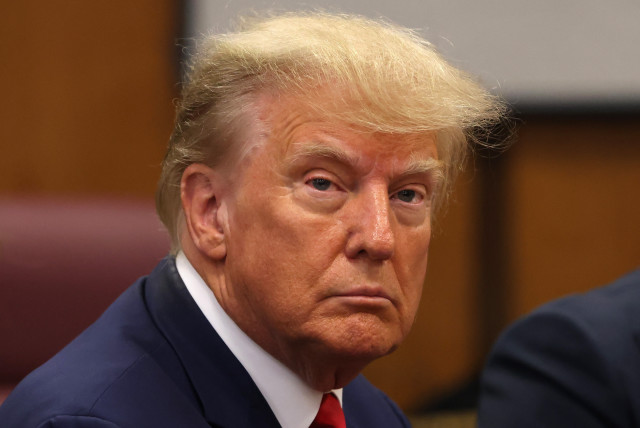 Former U.S. President Donald Trump appears in court for an arraignment on charges stemming from his indictment by a Manhattan grand jury following a probe into hush money paid to porn star Stormy Daniels, in New York City, U.S., April 4, 2023. (credit: Andrew Kelly/Reuters)