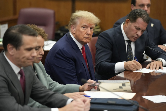  Former US President Donald Trump appears in court with members of his legal team for an arraignment on charges stemming from his indictment by a Manhattan grand jury following a probe into hush money paid to porn star Stormy Daniels, in New York City, US, April 4, 2023. (credit: REUTERS/SETH WENIG/POOL)