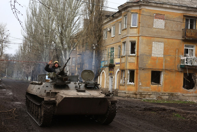 Ukrainian servicemen drive towards the frontline during heavy fighting at the frontline of Bakhmut and Chasiv Yar, in Chasiv Yar, Ukraine, April 12, 2023. (photo credit: REUTERS/KAI PFAFFENBACH)