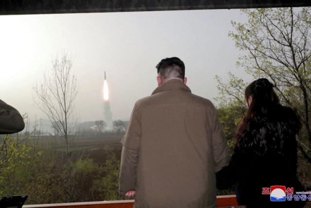  North Korean leader Kim Jong Un and his daughter Kim Ju Ae watch a test launch of a new solid-fuel intercontinental ballistic missile (ICBM) Hwasong-18 at an undisclosed location in this still image of a photo used in a video released on April 14, 202 (credit: KCNA/VIA REUTERS)