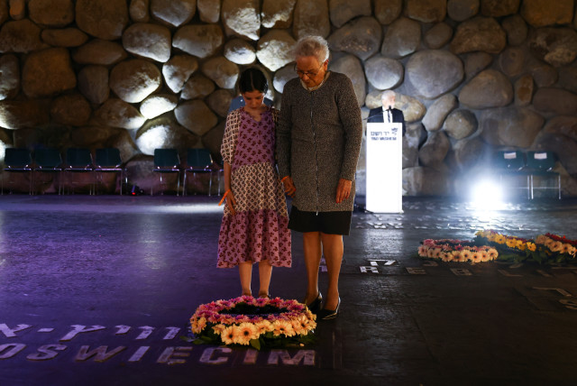  People pay tribute during a wreath-laying ceremony marking Holocaust Remembrance Day in the Hall of Remembrance at Yad Vashem, the World Holocaust Remembrance Centre, in Jerusalem, April 18, 2023. (credit: RONEN ZVULUN/REUTERS)
