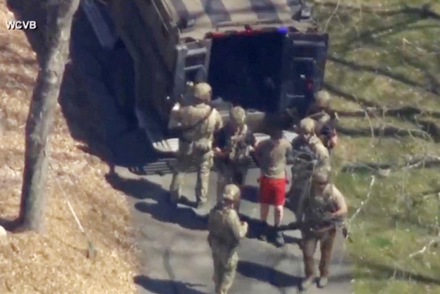  FBI agents arrest Jack Teixeira, an employee of the US Air Force National Guard, in connection with an investigation into the leaks online of classified U.S. documents, outside a residence in this still image taken from video in North Dighton, Massachusetts, US, April 13, 2023. (credit: WCVB-TV VIA ABC VIA REUTERS)