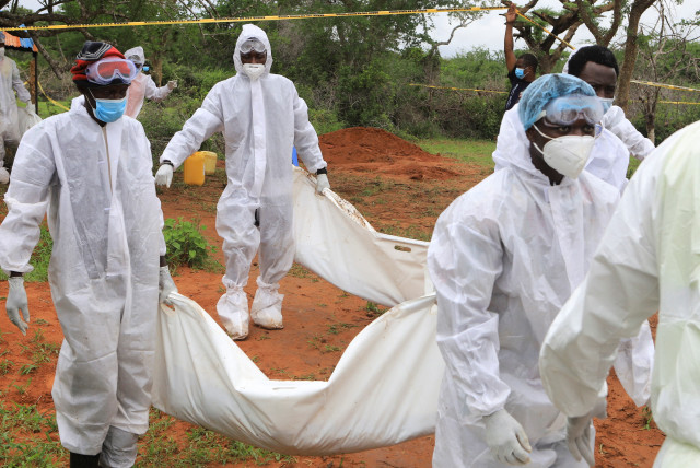  Forensic experts and homicide detectives carry the bodies of suspected members of a Christian cult named as Good News International Church, who believed they would go to heaven if they starved themselves to death, after their remains were exhumed from their graves in Shakahola forest of Kilifi coun (credit: REUTERS/STRINGER)