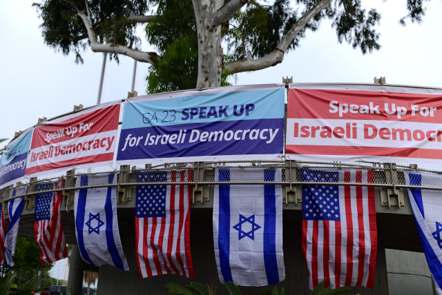  Israelis holding the US and Israeli flag protest outside the Jewish Federation of North America (JFNA) conference, in Tel Aviv, on April 23, 2023. (credit: TOMER NEUBERG/FLASH90)
