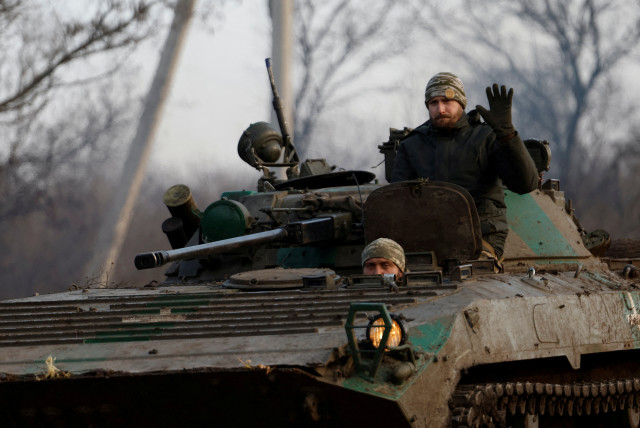  A Ukrainian serviceman waves from a tank, as Russia's attack on Ukraine continues, during intense shelling on Christmas Day at the frontline in Bakhmut, Ukraine, December 25, 2022. (credit: CLODAGH KILCOYNE/ REUTERS)