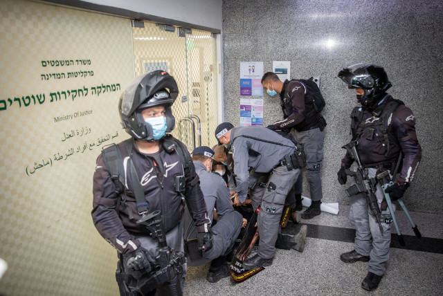  Police arrest a demonstrator during a protest outside Machash, the Police Internal Investigations Department, in Jerusalem on February 9, 2021. (credit: YONATAN SINDEL/FLASH90)