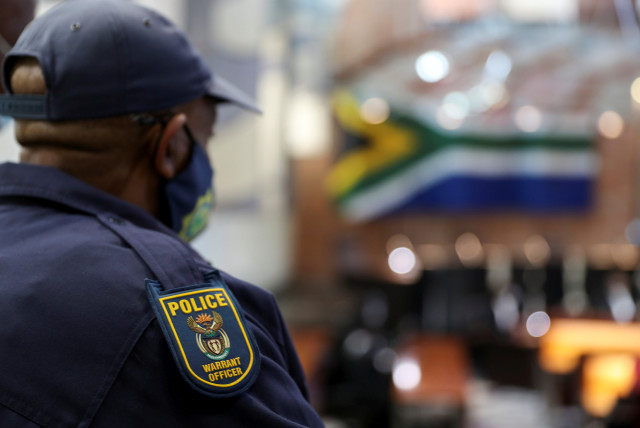  A police officer looks on ahead of a ruling on whether former South African president Jacob Zuma should be punished for defying summons at an inquiry into corruption during his time in power, at the Constitutional Court in Johannesburg, South Africa, June 29, 2021. (credit: SIPHIWE SIBEKO/REUTERS)