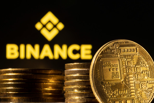  A representation of the cryptocurrency is seen in front of Binance logo in this illustration taken, March 4, 2022.  (credit: REUTERS/DADO RUVIC/ILLUSTRATION)