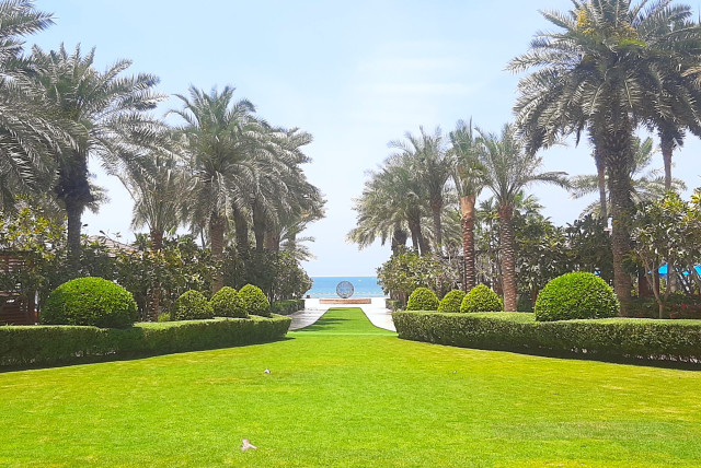  A MANICURED LAWN stretches from the Four Seasons Resort Dubai to Jumeirah Beach on the Persian Gulf. (credit: ARI BAR-OZ)