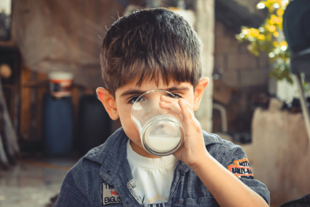  Illustrative image of a child drinking milk. (credit: PEXELS)