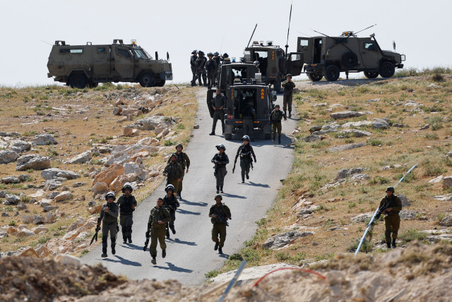  Israeli troops take position during clashes between Palestinians and Israeli troops after Israeli machinery demolish a school near Bethlehem in the West Bank May 7, 2023 (credit: REUTERS/MUSSA QAWASMA)