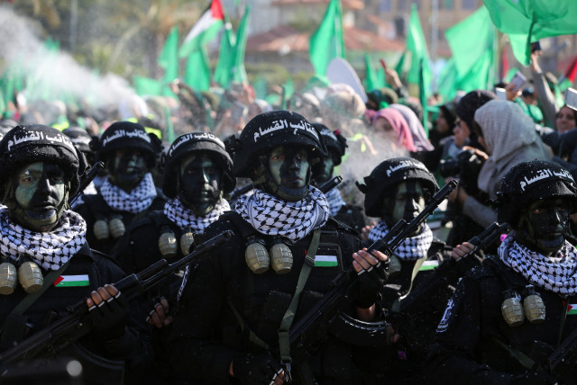  Members of Qassam Brigades choir attend a rally marking the 35th anniversary of the Hamas movement's founding, in Gaza City December 14, 2022.  (credit: IBRAHEEM ABU MUSTAFA/REUTERS)