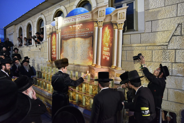 The Admor of Boyan lighting candles in memory of the 45 victims of Mount Meron, on the roof of the tomb of Rabbi Shimon Bar Yochai in Meron. (credit: Eli Segal)
