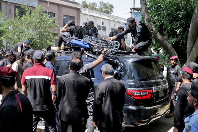  Pakistan security forces guard a vehicle carrying former Prime Minister Imran Khan after his arrest at a court in Islamabad, Pakistan, May 9, 2023 (credit: REUTERS/STRINGER)